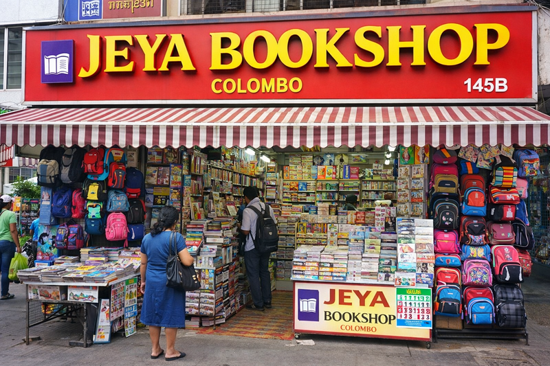 Street view of Colombo bookstore with backpacks, self-help, finance, and fiction books for sale