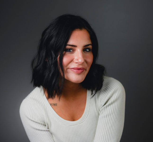 Female author with dark hair in white sweater, portrait for book fiction and self-help genre